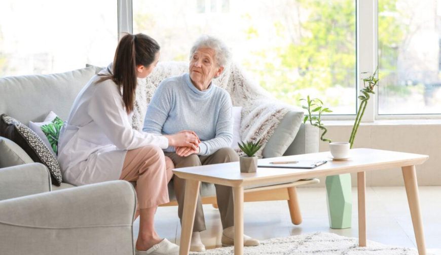 Caregiver providing compassionate home care services to a senior at home